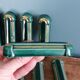 Poët Laval knife rest in emerald green ceramic and gold.