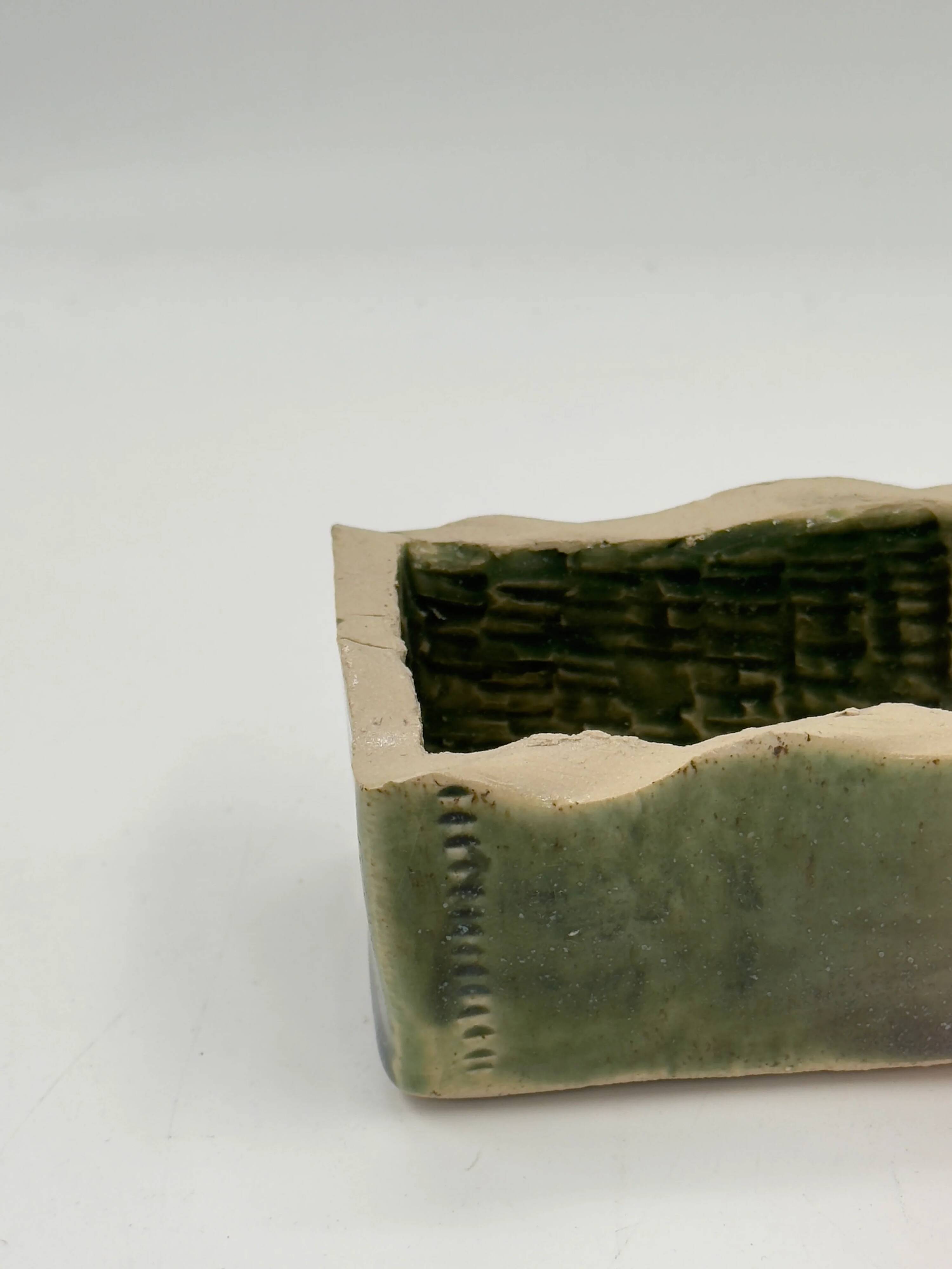 Rectangular ceramic vase signed, woven interior.