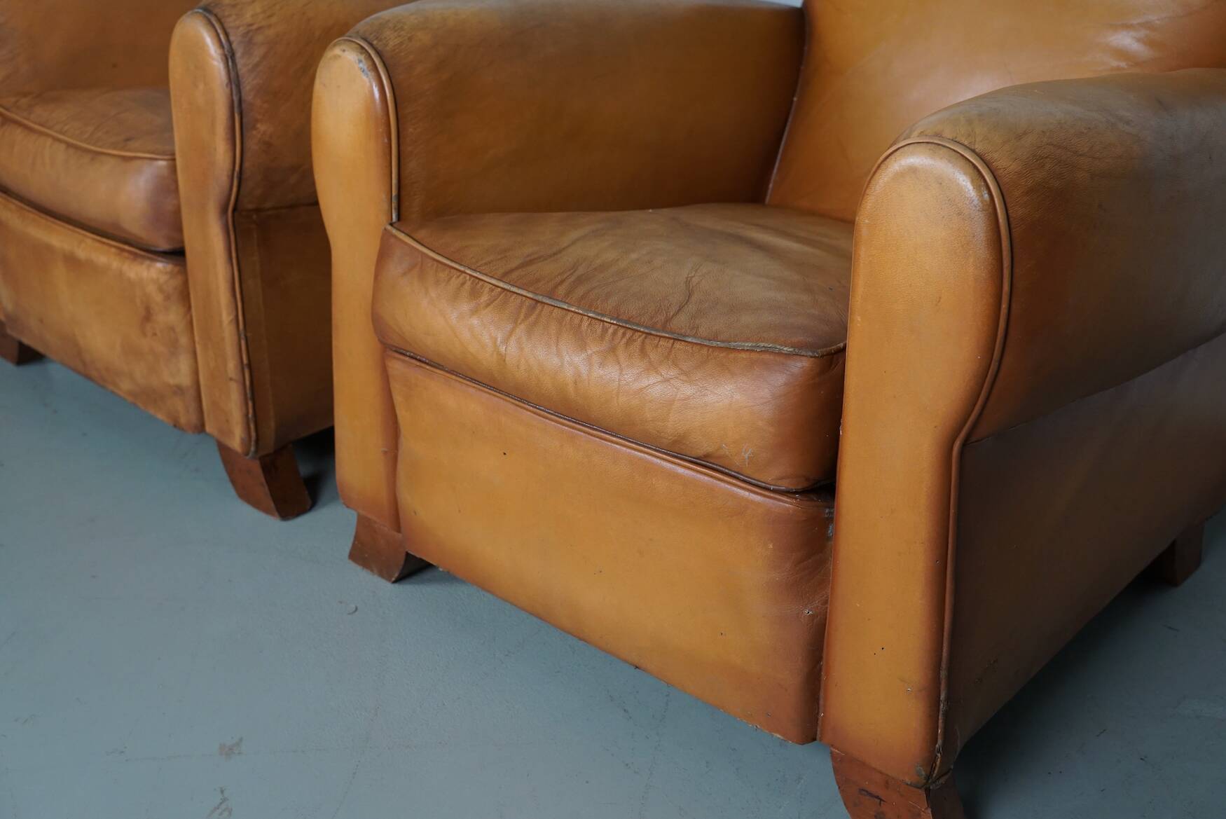 Pair of French Cognac Moustache Back Leather Club Chairs, 1950s