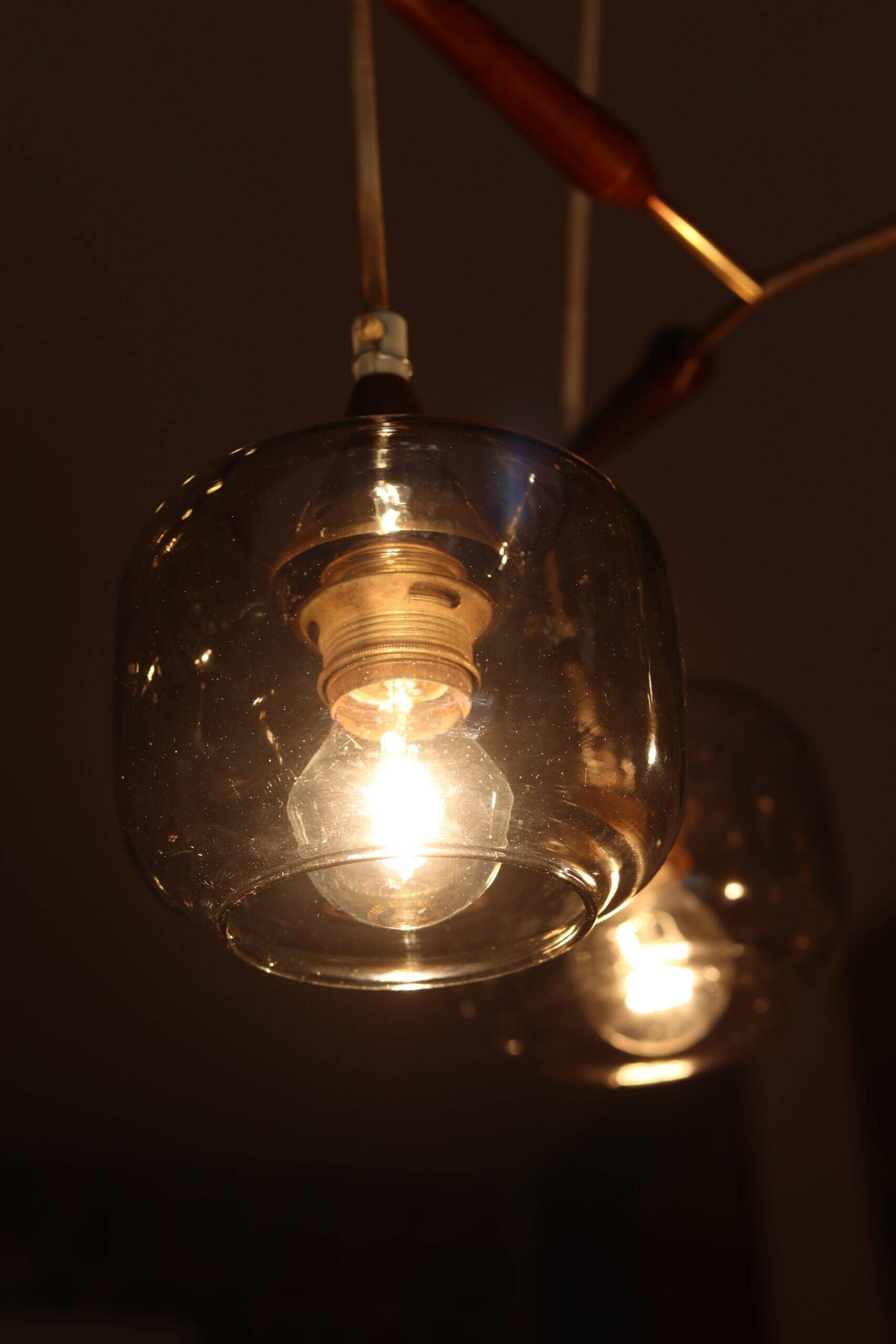 Scandinavian chandelier "Cascade" from the 1960s in brass, teak, and smoked glass.