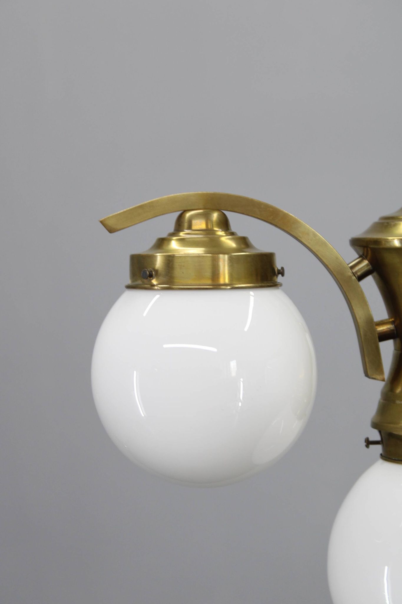 1930s Czechoslovak Art Deco brass chandelier with four opaline glass globes