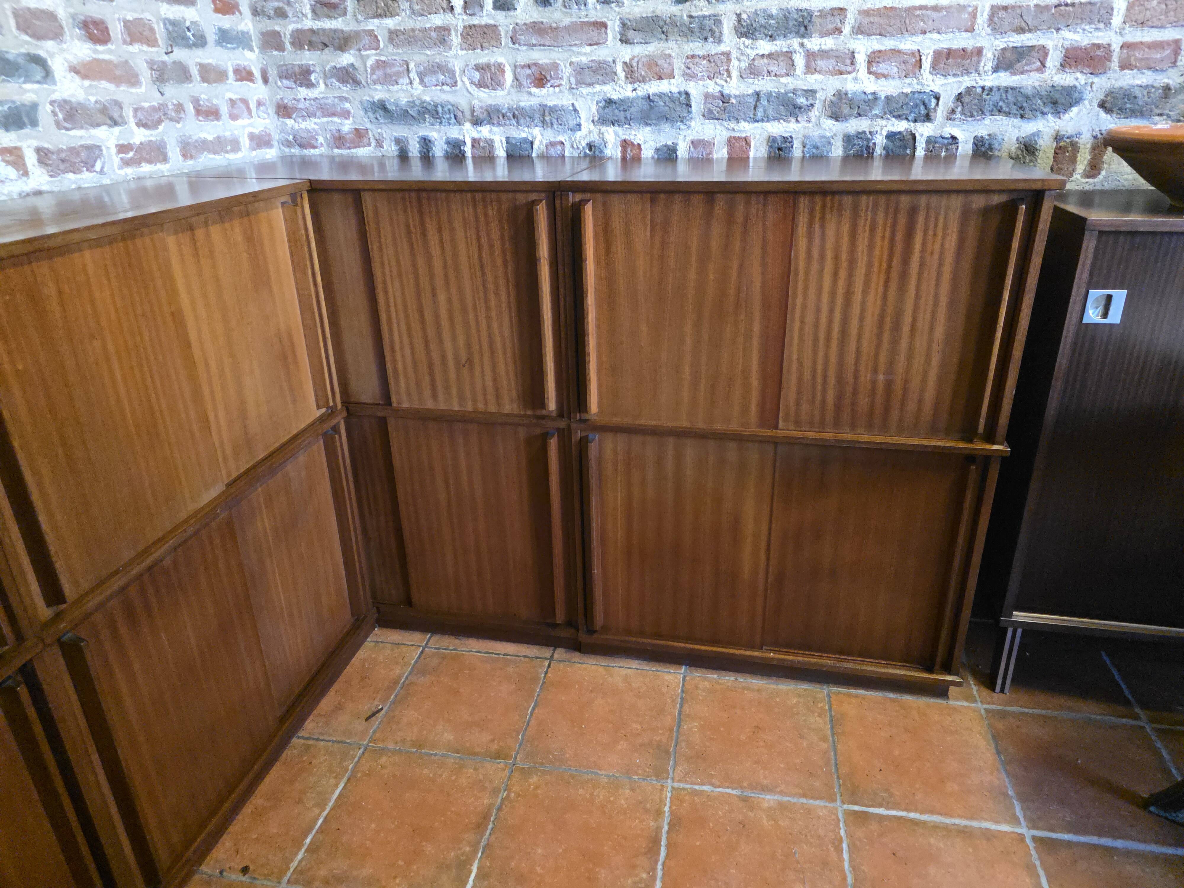 Modular corner library Oscar from the 1960s with sliding doors.
