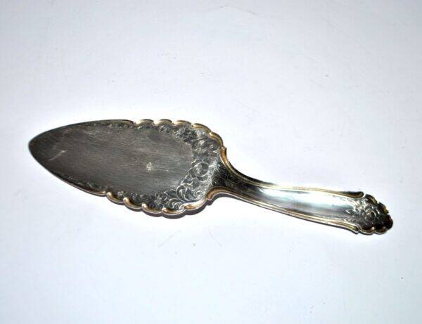 Vintage silver-plated pie server with rose decoration.