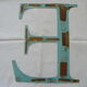 Old letter E painted metal sign