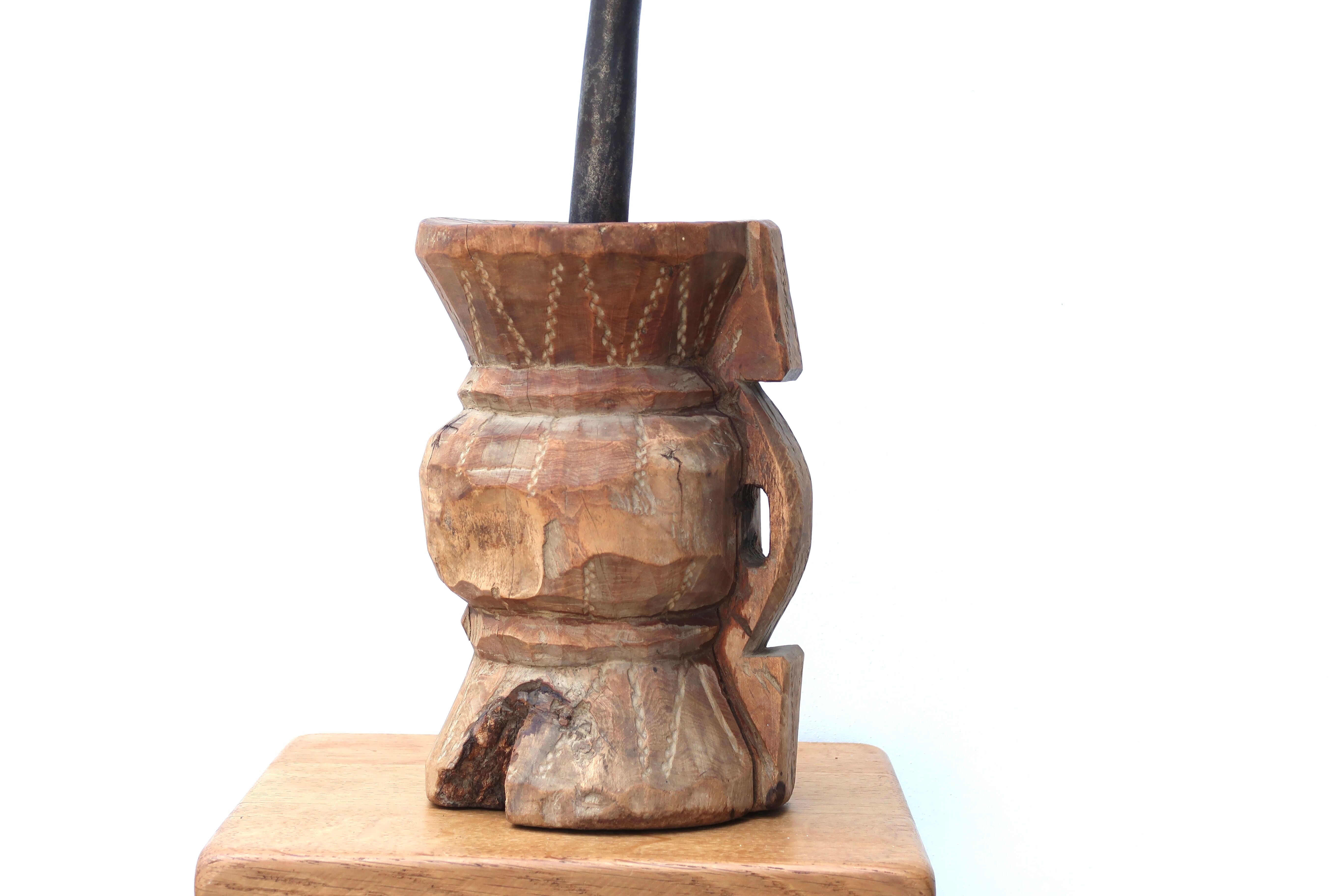 African mortar in carved wood, cast iron pestle, 70s
