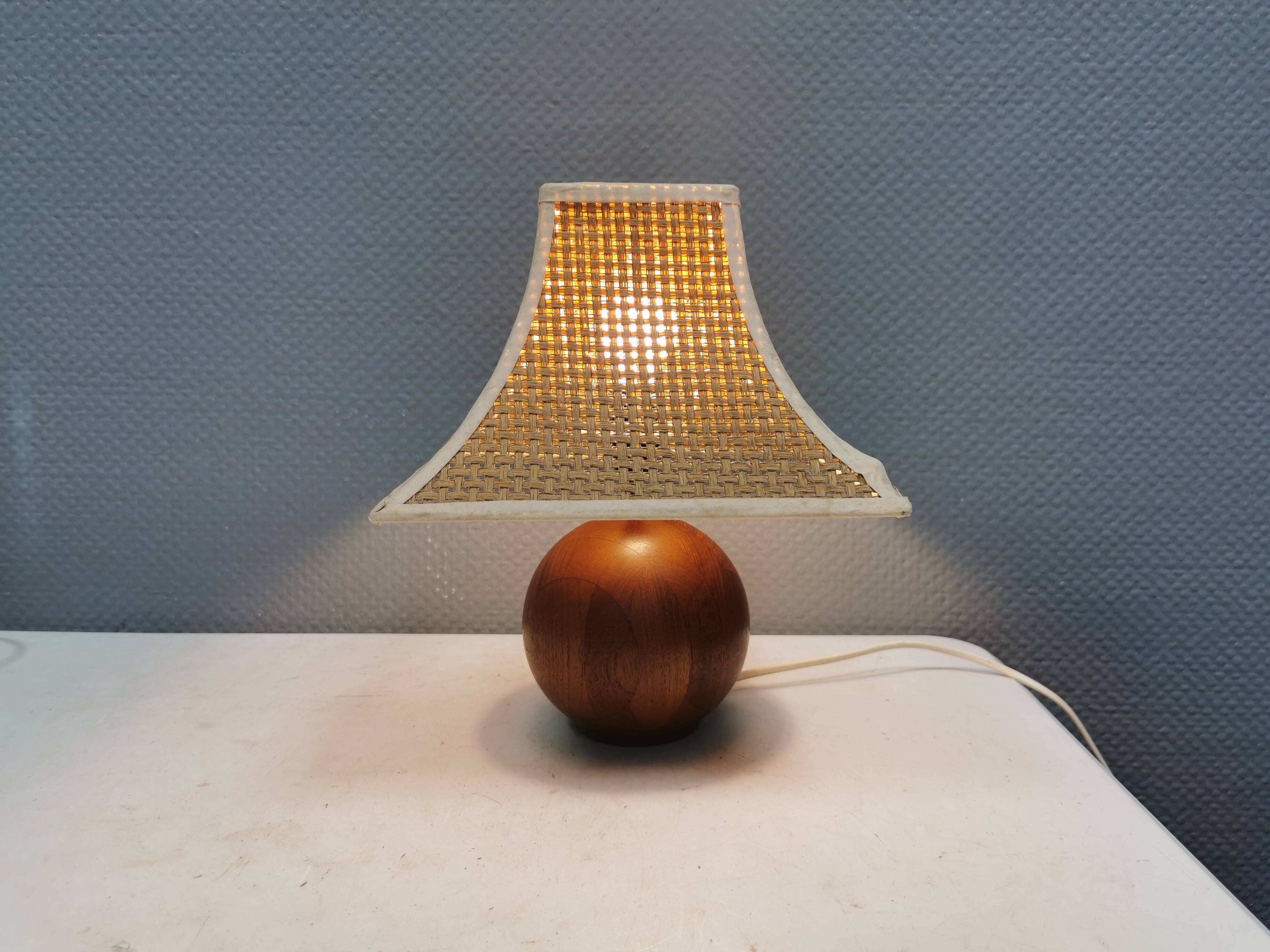 Very rare table lamp in turned teak wood with original braided shade. 1970s
