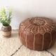 Moroccan-style brown leather pouf