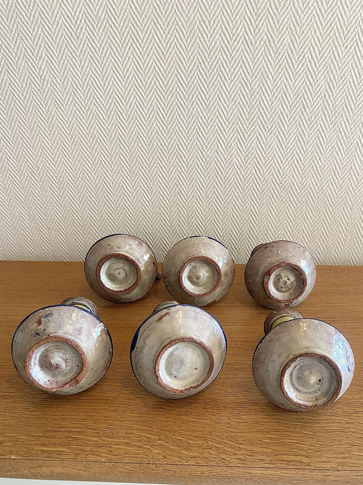 Many old glazed terracotta candlesticks.