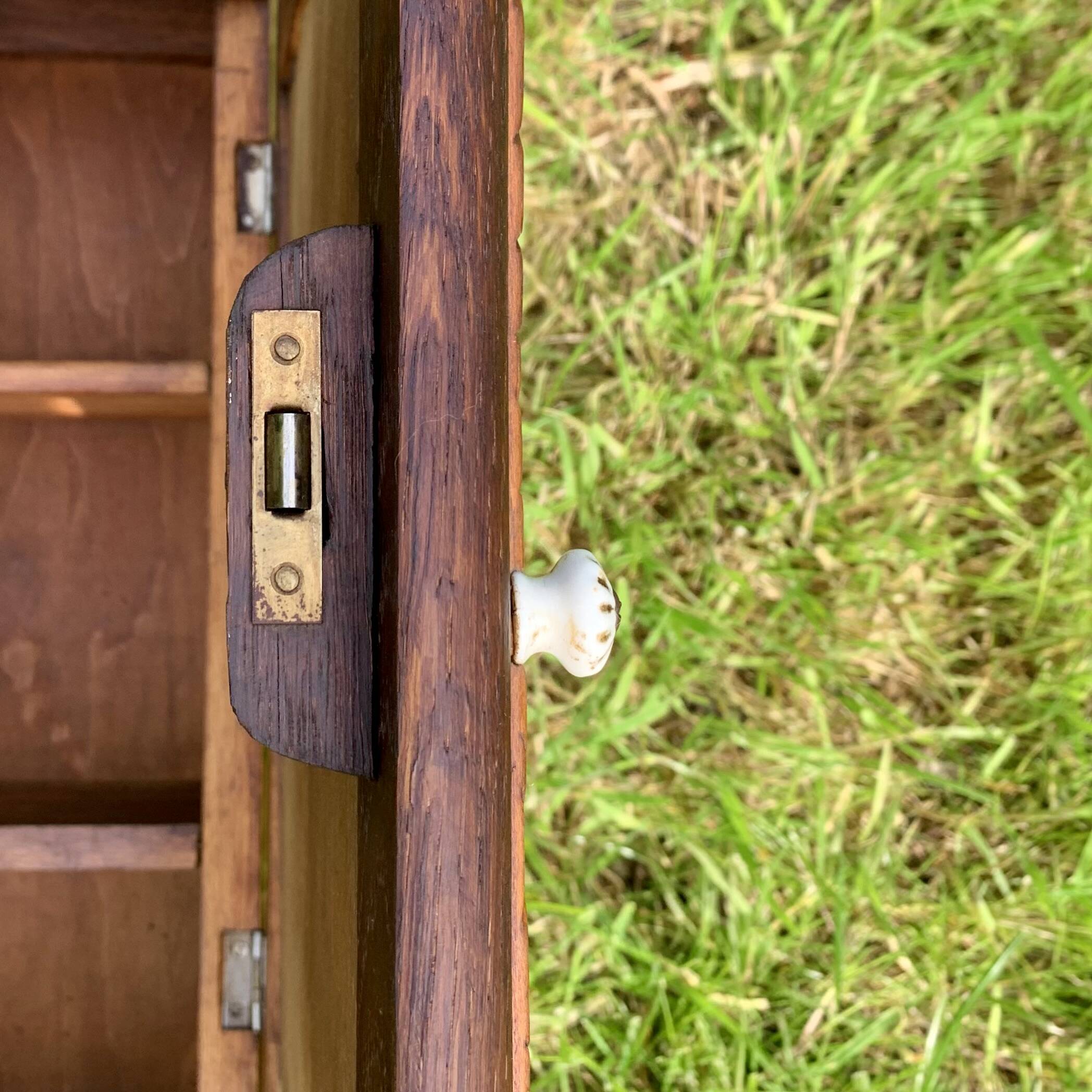 Old carved wooden medicine cabinet with beveled mirror