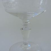 Suite of six champagne glasses on foot in engraved colorless crystal