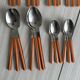 24 vintage stainless steel and orange plastic cutlery sets
