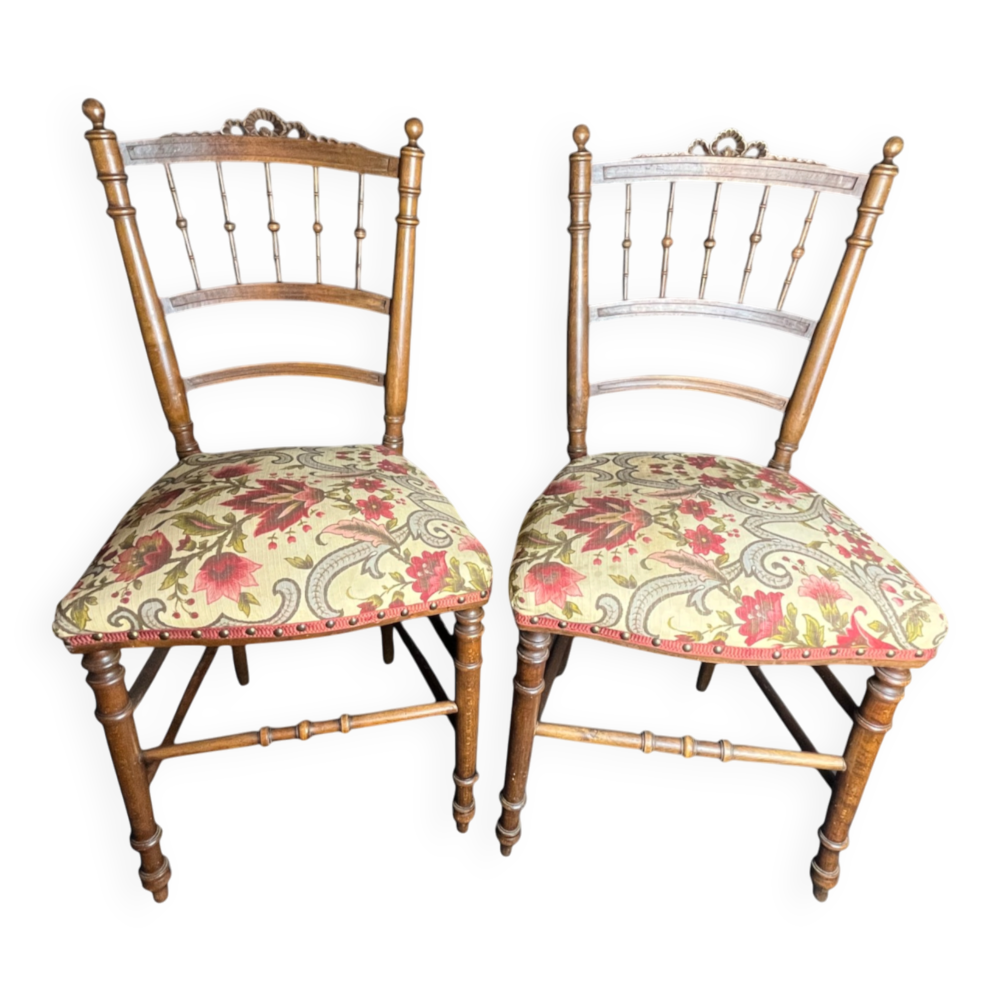Two floral upholstered music chairs from the early 20th century.