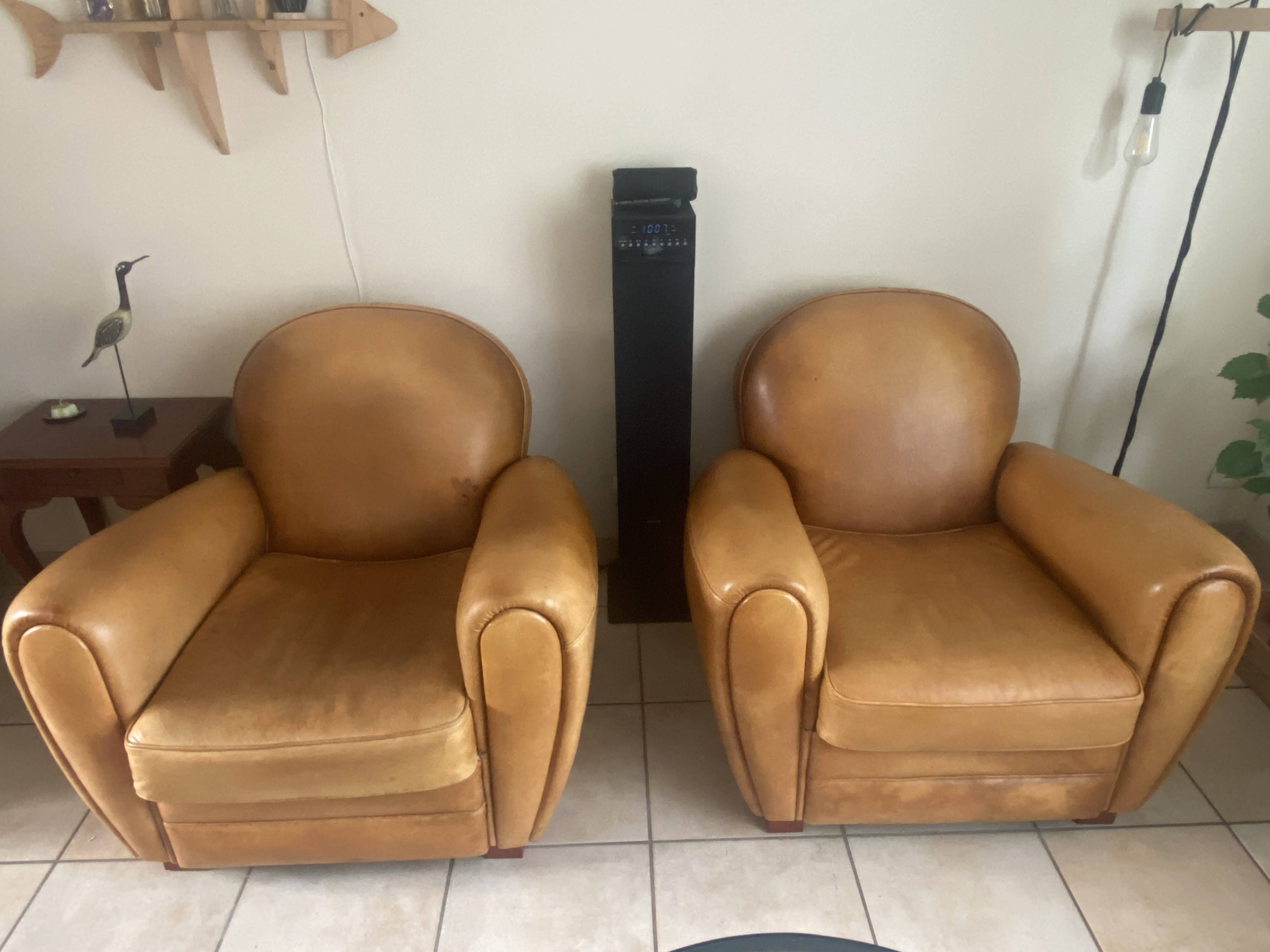 Brown leather club armchairs with an antique finish.
