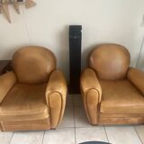 Brown leather club armchairs with an antique finish.