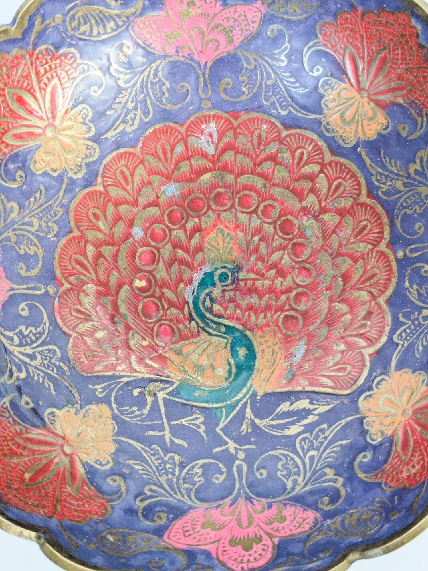 Vintage brass bowl with peacock motif, painted enamel, scalloped edge on a pedestal.