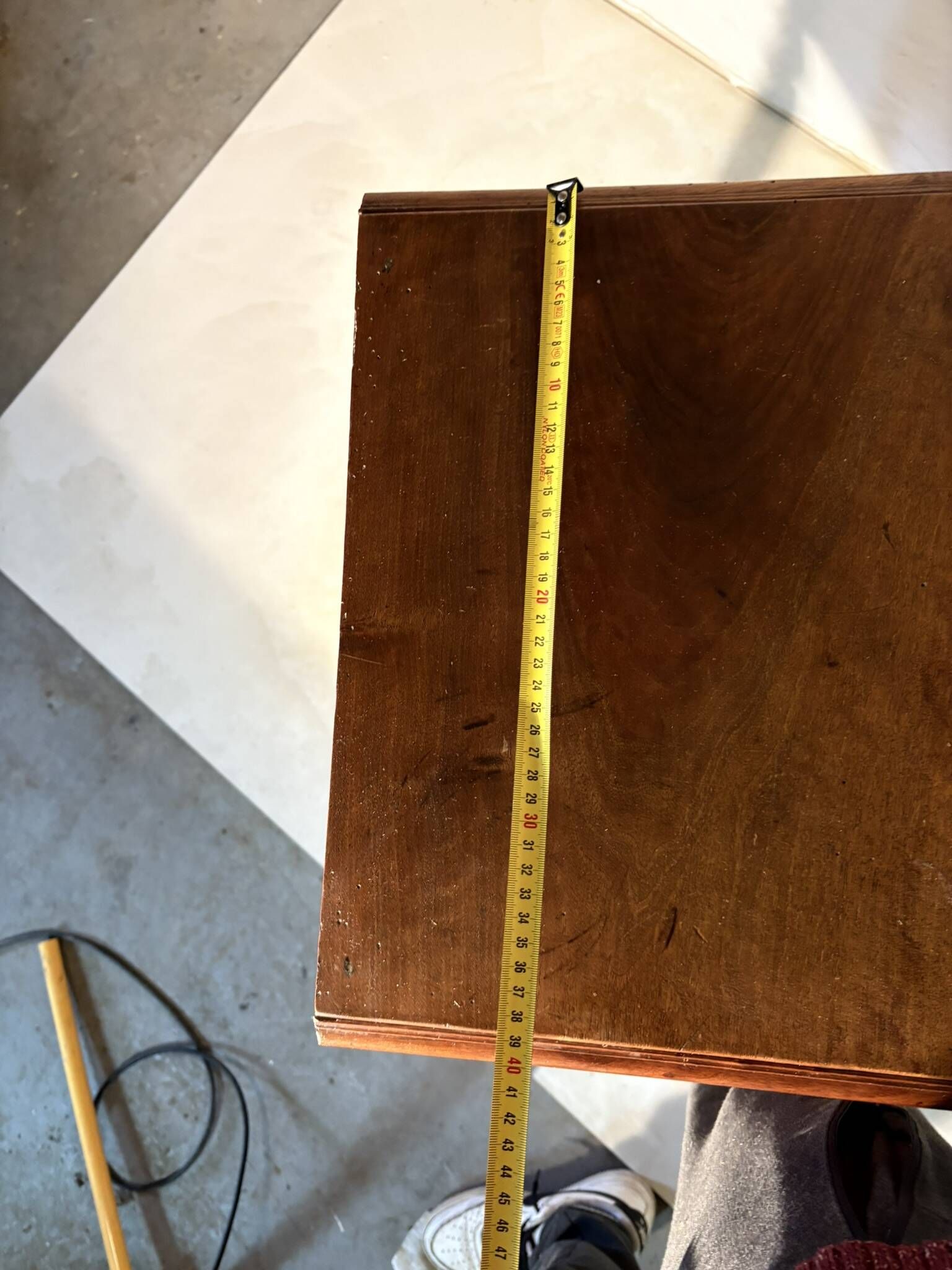 Antique wooden bedside table with turned legs.