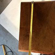 Antique wooden bedside table with turned legs.