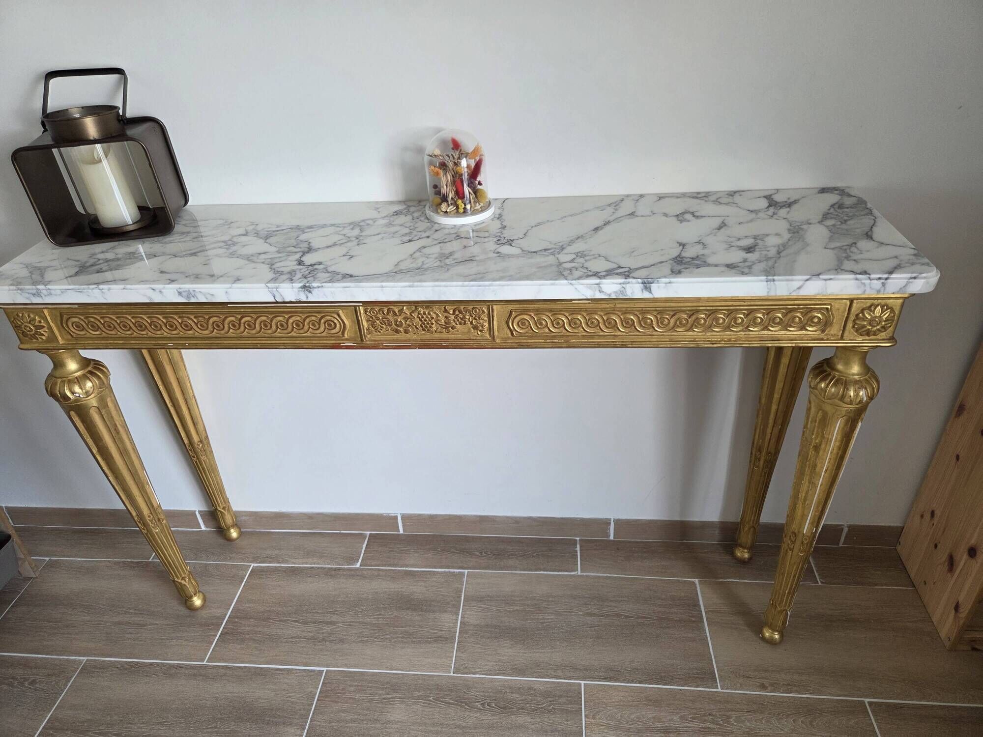 18th-century Italian console in gilded wood with a marble top.