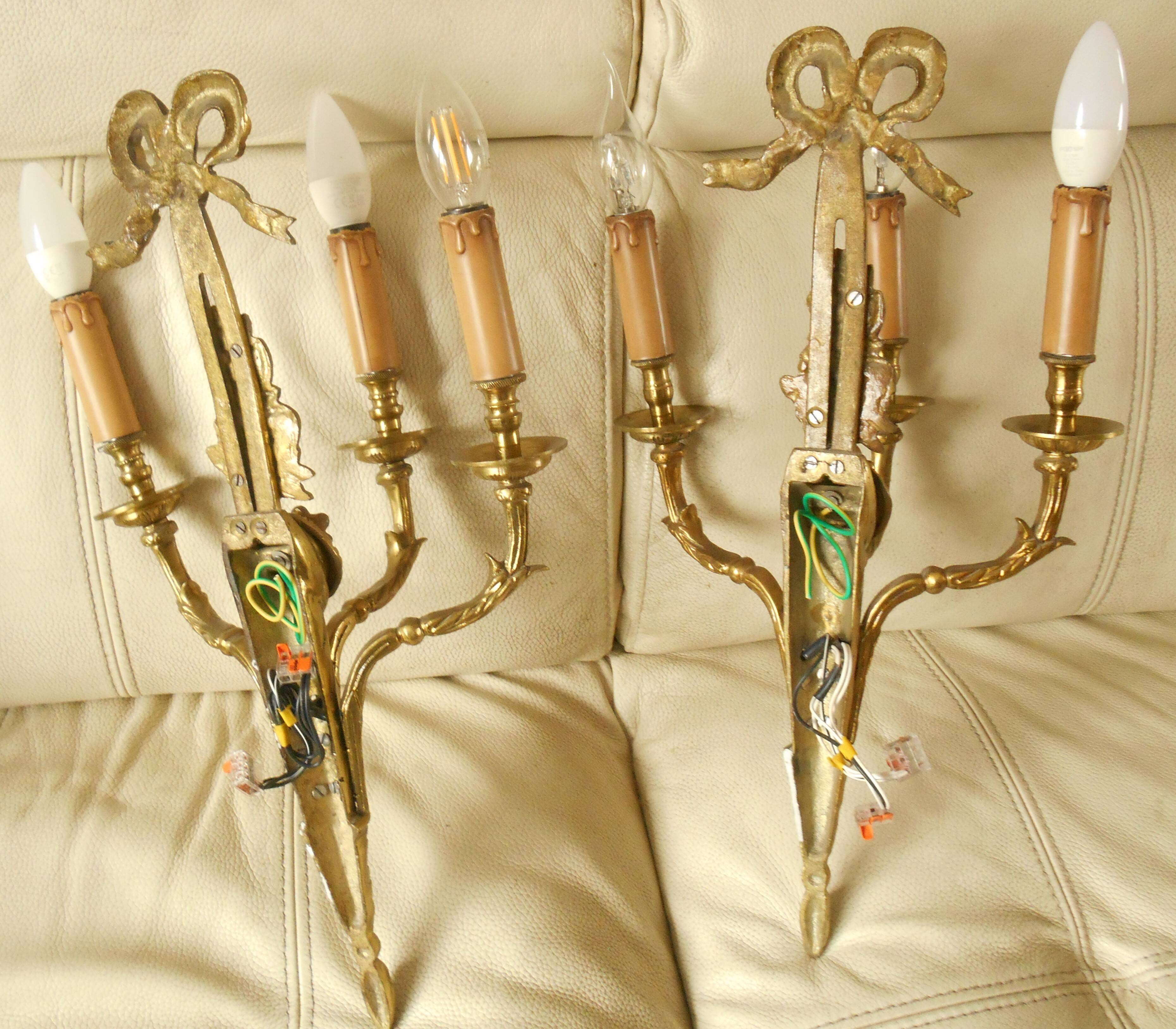 Pair of gilded bronze wall sconces with three lights