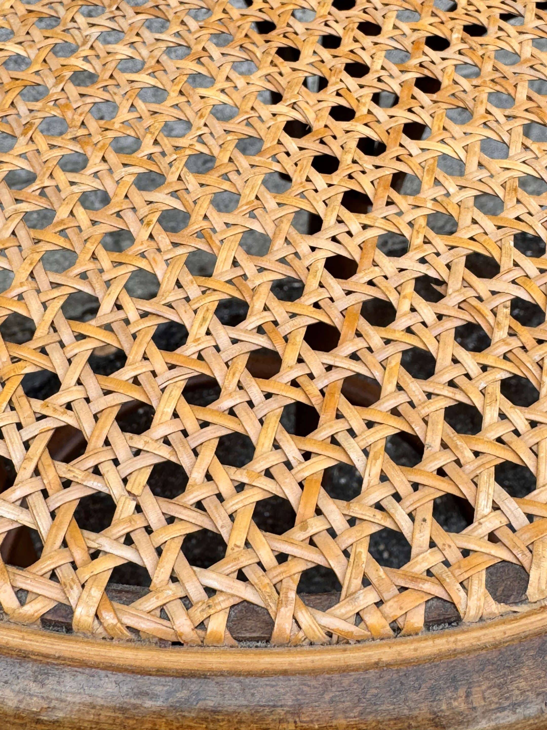 Old high stool in curved wood with caned seat