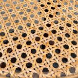 Old high stool in curved wood with caned seat