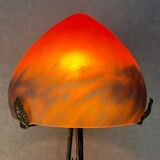 Contemporary mushroom lamp, wrought iron base and orange glass shell with blue hues in the art deco style