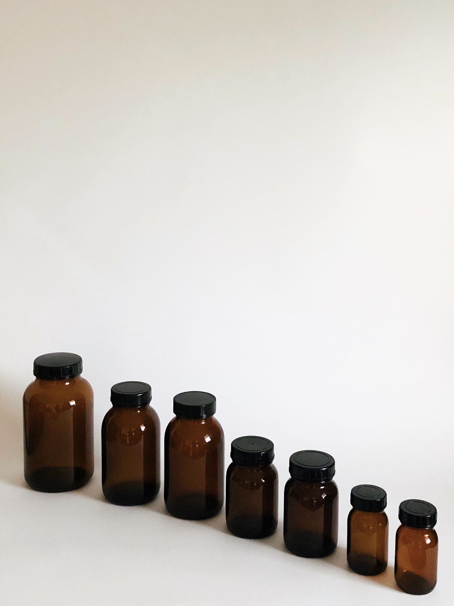 Lot of 7 bottles of amber glass apothecary style
