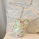Ceramic dabbling jug enamelled floral motif