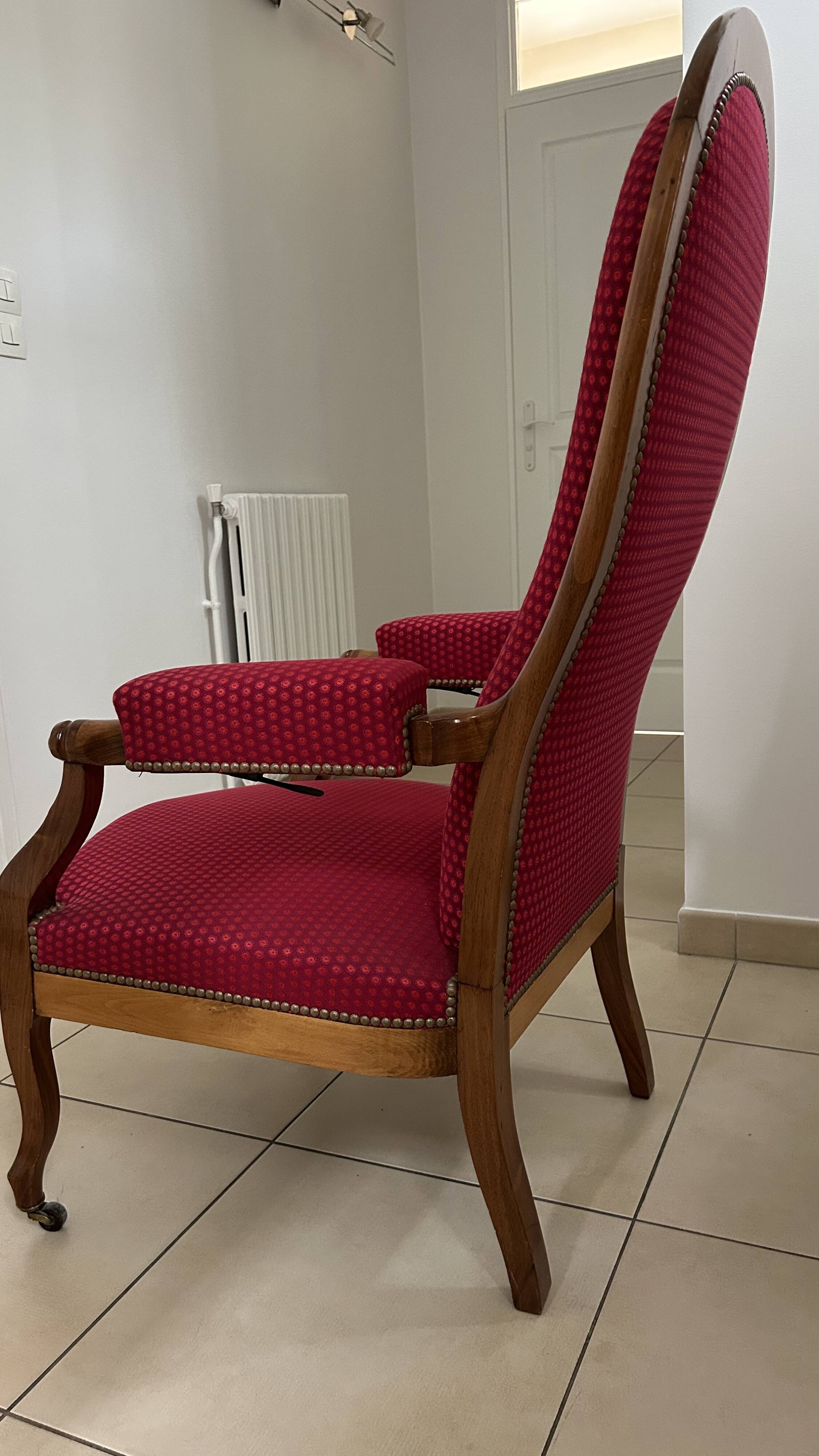 Antique Louis Philippe armchair in walnut and red fabric.
