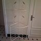 Cream and brass corner bakery shelf in wrought iron