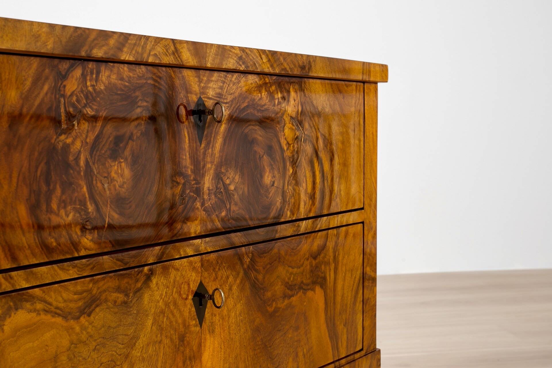 Elegant pair of Biedermeier style walnut commodes, Germany, French polish.