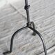 Antique tripod metal candlestick with knot decoration
