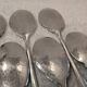 6 individual silver-plated metal sauce spoons with hammered baguette handles