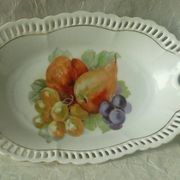 Pierced porcelain basket decorated with fruit still life.