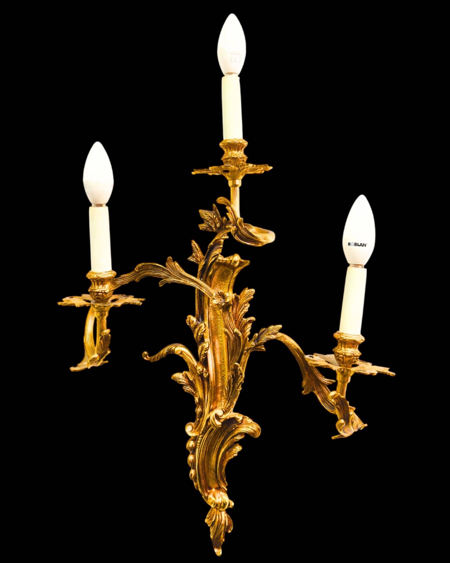 Pair of gilded bronze wall sconces in Rococo style, three lights.