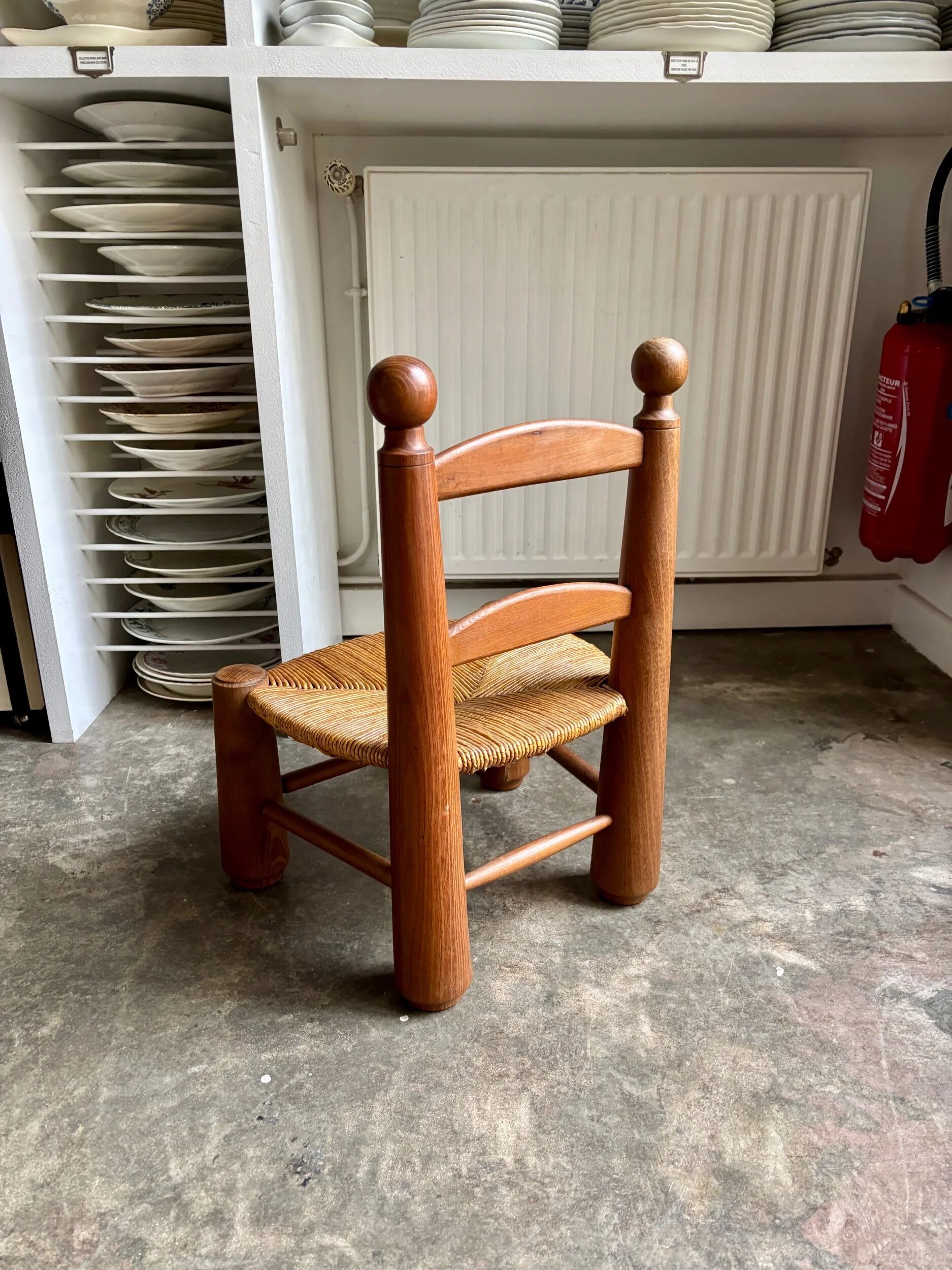 Brutalist low chair in dark wood and straw no. 3