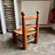 Brutalist low chair in dark wood and straw no. 3