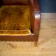 Antique club armchair of leather cloth