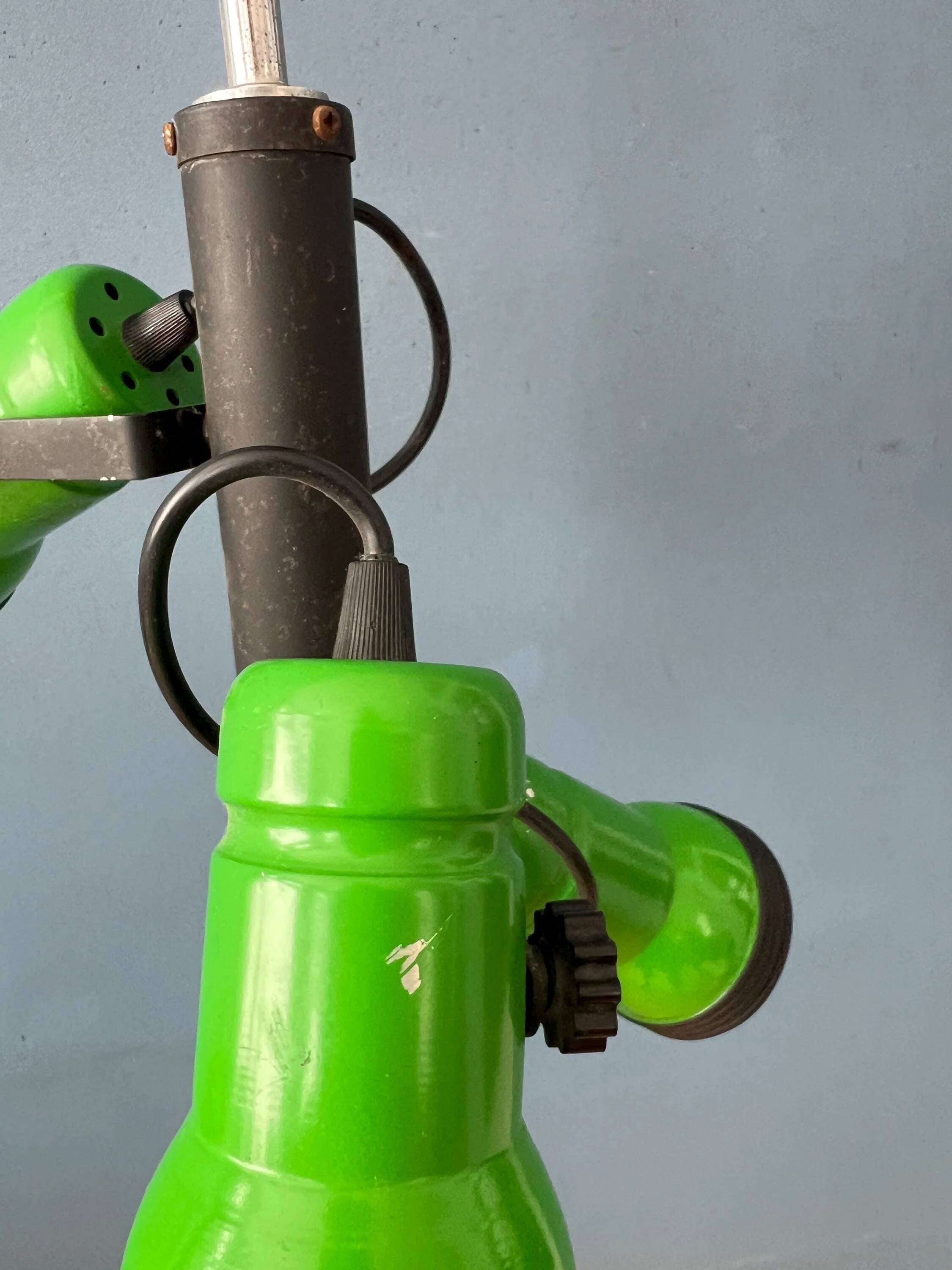 Vintage pendant light with three green spots.