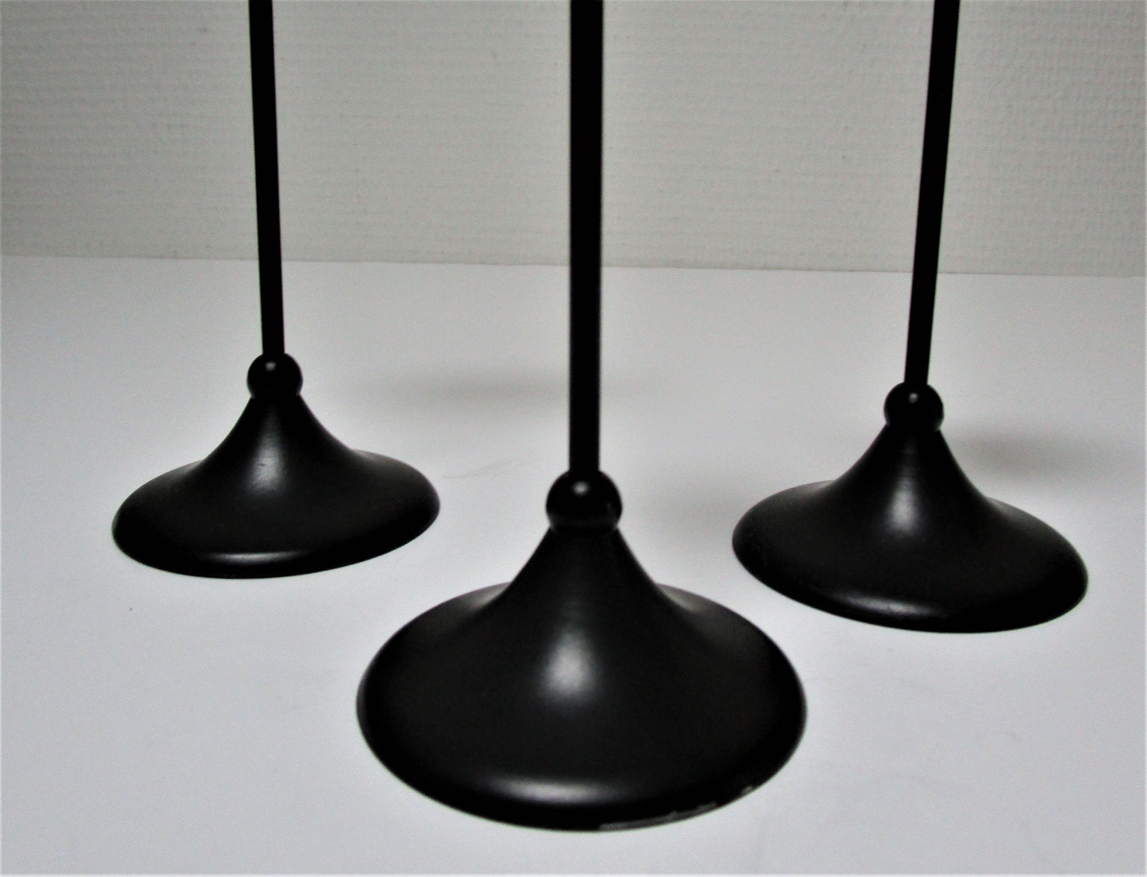 Three Scandinavian black lacquered metal candle holders