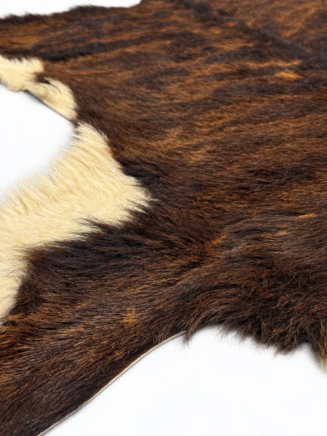 Vintage striped hide rug, natural brown and cream.
