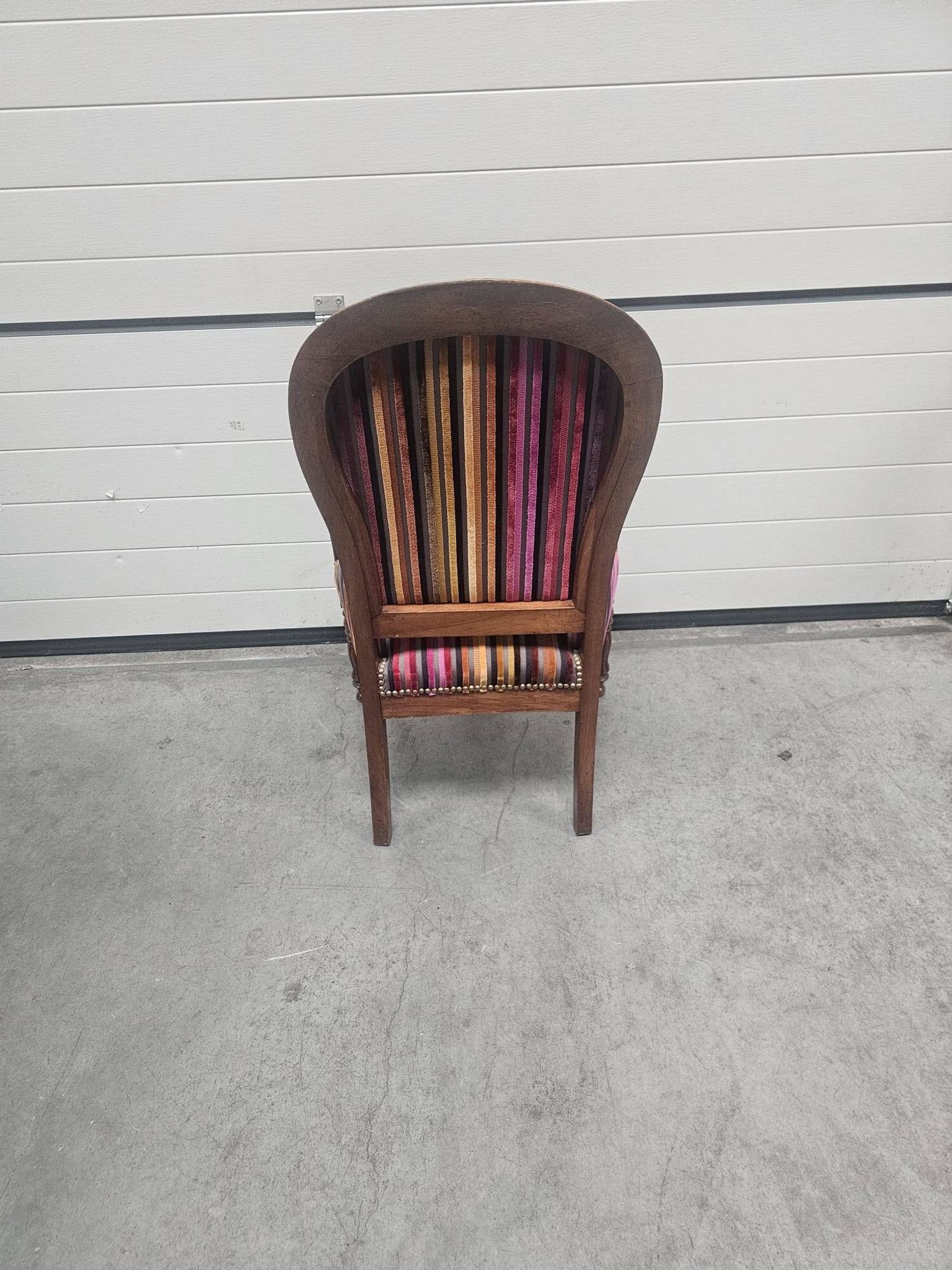 Antique striped multicoloured velvet armchair with turned legs.