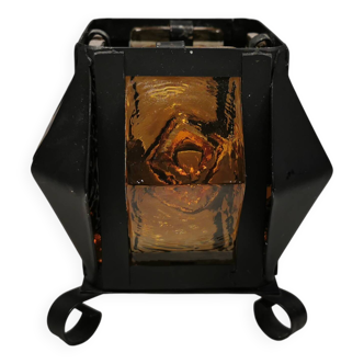 Candleholder in cast iron and orange color hard pressed glass.