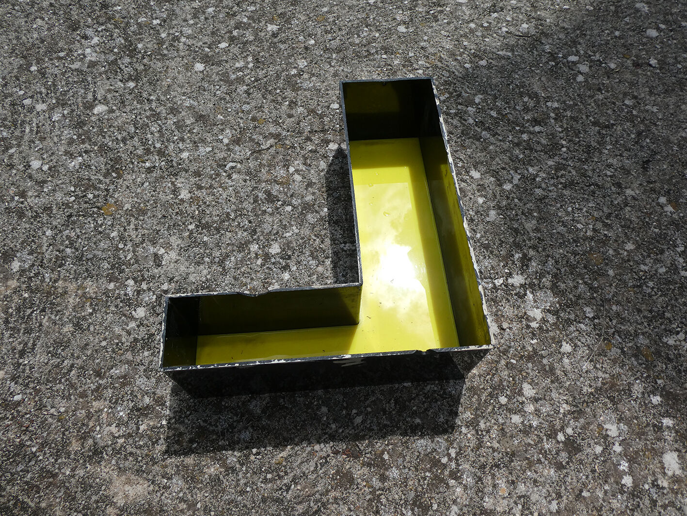 Letter "l" of industrial sign yellow and black