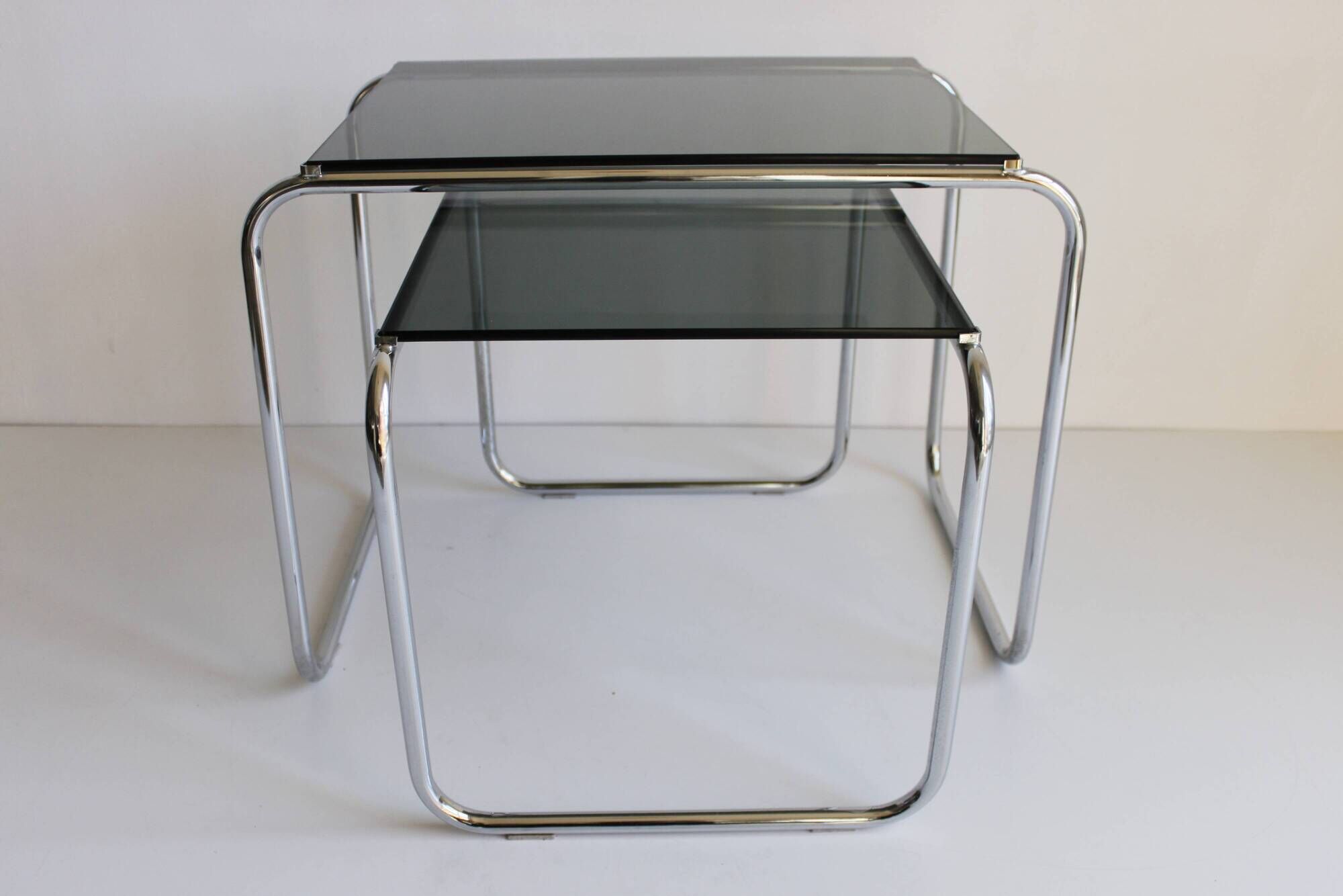 Tubular steel and smoked glass side tables, set of 2
