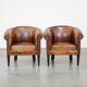 Set of 2 subtle, stately and sturdy club chairs made of sheepskin