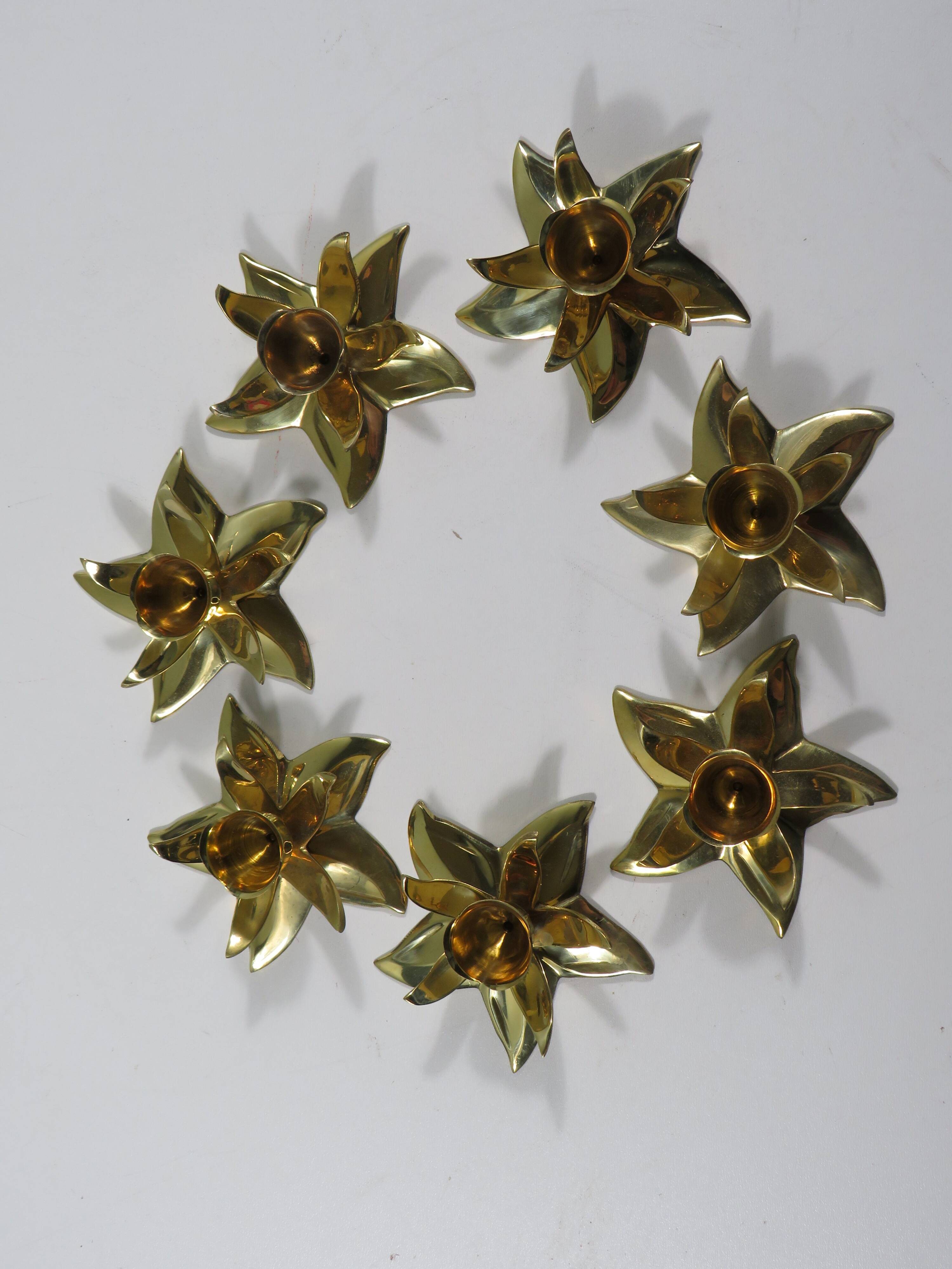 Set of 7 heavy shiny brass flower shaped candle holders, 1970-1980