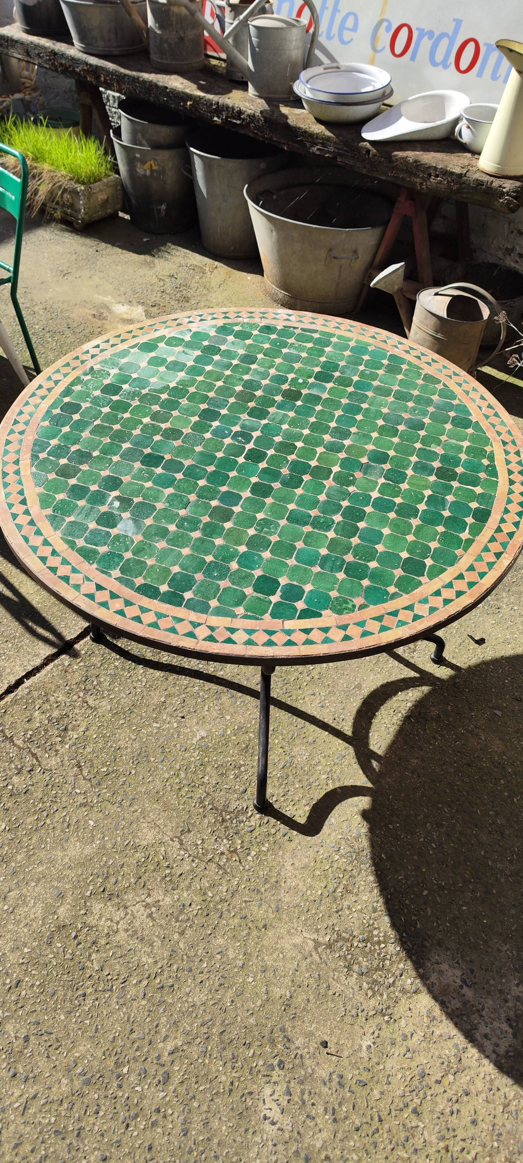 Round zellige table with metal legs and green tile top