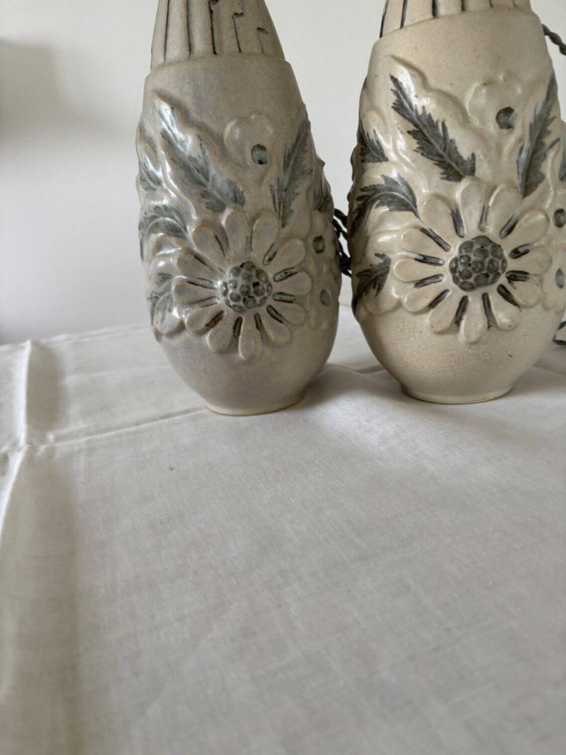Pair of white glazed stoneware lamp bases, 20th-century floral decoration.