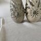Pair of white glazed stoneware lamp bases, 20th-century floral decoration.